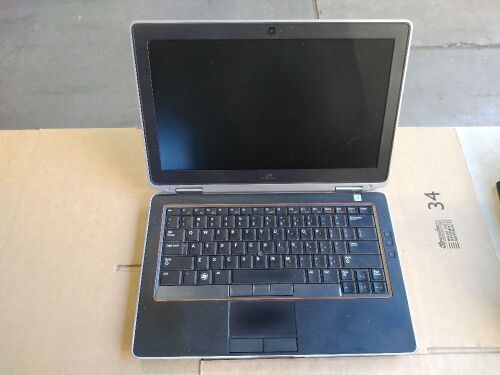 DNL Dell Latitude E6320 | No HardDrive [S/N: HM1QGV1 ] w/ Charger | Minor scratches and scuff marks.