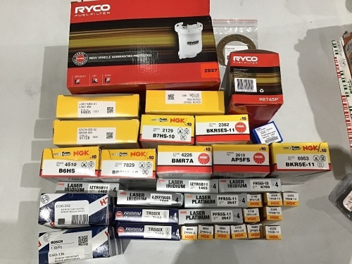 Box of packs of spark plugs, various sizes, and Ryco filters. Please refer to images of items.