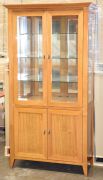 2 Door Timber Display Cabinet. Has 3 glass shelves, 2 Door storage below . Dimensions 1070W x 450D x 2000H mm.