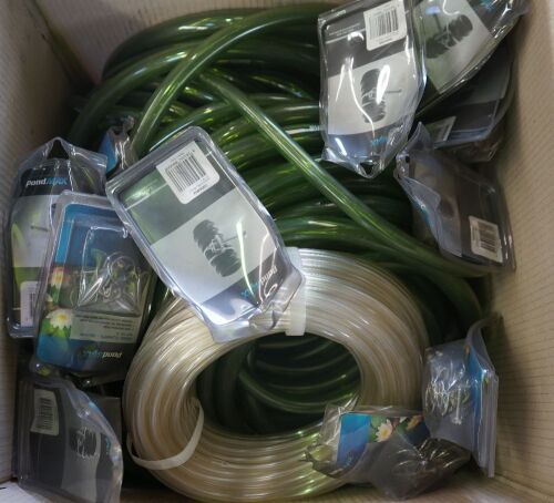 Box of assorted plastic tubing and hose clamps.