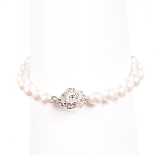 Lovely Single Strand Bracelet Of Japanese Near Round Akoya Pearls On White Silk.