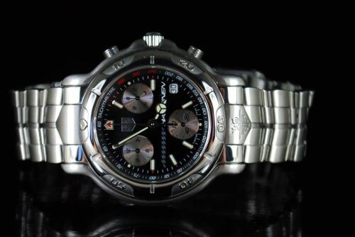 DNL Retail Replacement Value $8,325.00 - One New Authentic Gents Tag Heuer 6000 Series Mika Hakkinen Signed Signature 1/10th chronograph "Limited Edition" wrist watch with a black dial.