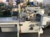 PFM MOTORISED FLOW WRAPPING MACHINE Model: PFM-30 with Approx 200mm Rubber Belt Infeed Conveyor, Take-Out Conveyor, Overhead Wrap Feed-Out Station, Control to 415V 3 Phase Electric Motor and Switch on Mobile Base - 2