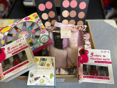 One box various women’s products, nail polish, moisturising creams and foundation make up.