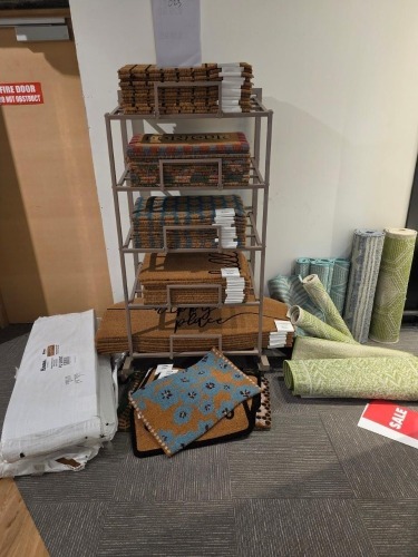 Fixture inc mix welcome mats and 10x mix quantities of small rugs (unknown size) Must take fixture